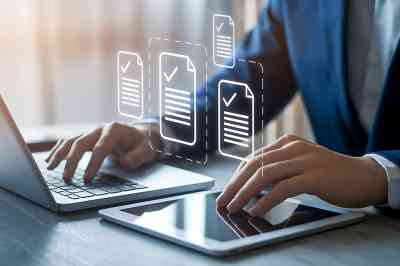 Laptop mit zwei Händen und Check-Icons - © Din Nasahrudin - stock.adobe.com